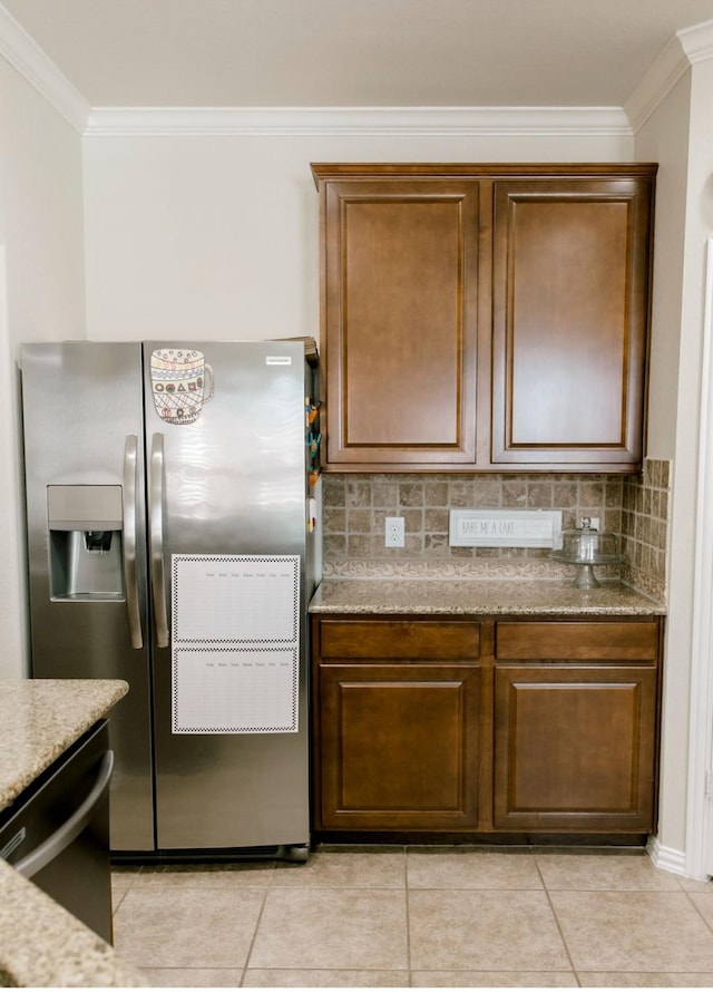 kitchen with appliances with stainless steel finishes, backsplash, and ornamental molding