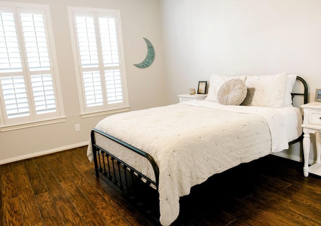 bedroom featuring baseboards and wood finished floors