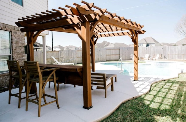 view of patio / terrace featuring outdoor dining space, a fenced backyard, and a pergola