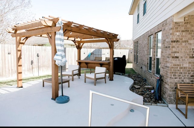 view of patio / terrace with a fenced backyard and a pergola