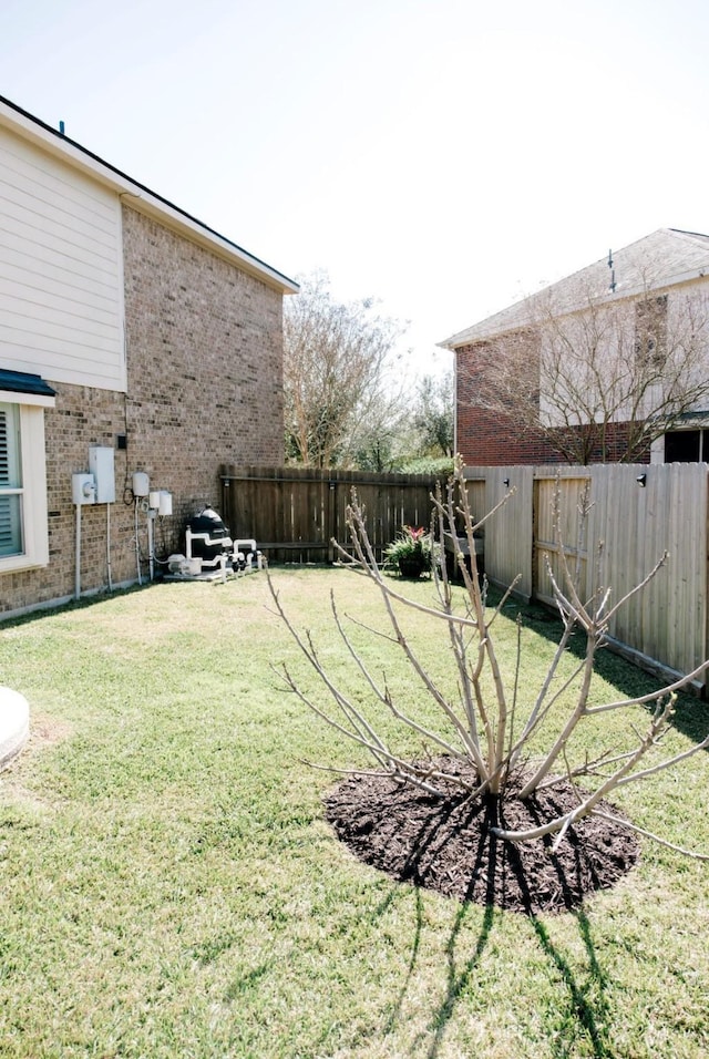 view of yard with a fenced backyard