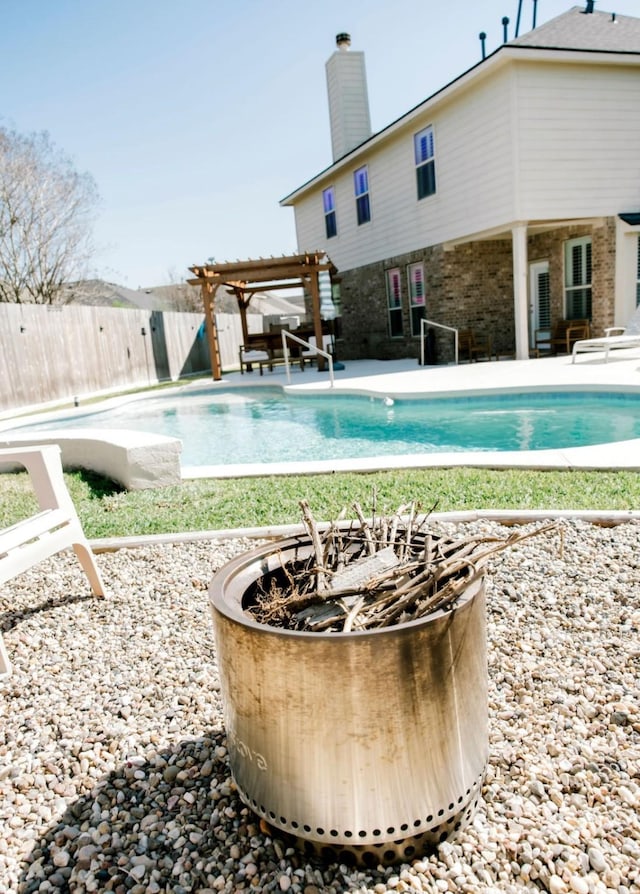 view of pool with a fenced in pool, a patio area, fence, a pergola, and a fire pit