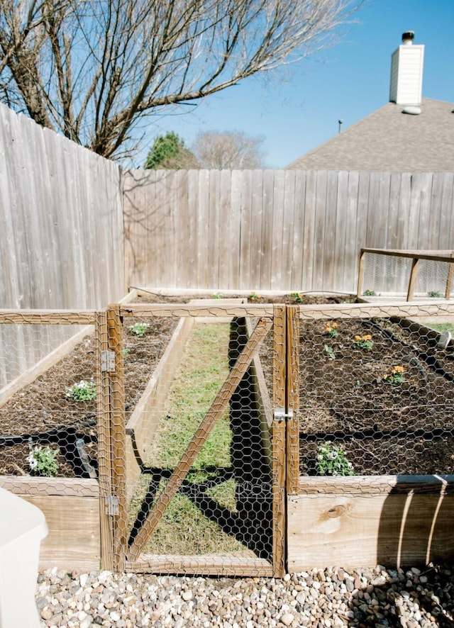 view of yard featuring a vegetable garden and fence