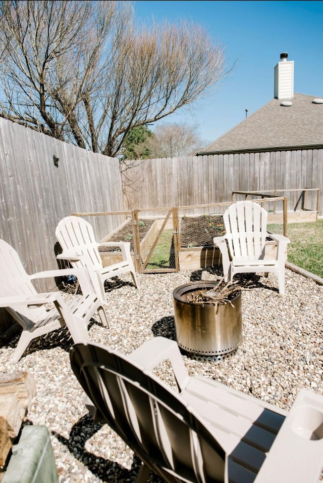 view of patio with a garden and a fenced backyard