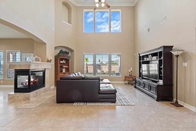 living room featuring baseboards, visible vents, and a multi sided fireplace