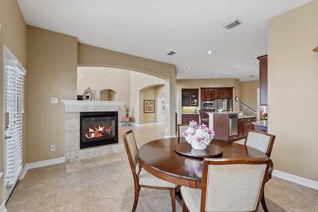 dining space with recessed lighting, a fireplace, visible vents, and baseboards