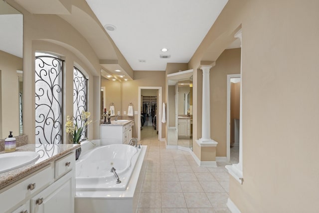 full bathroom with decorative columns, visible vents, a sink, a jetted tub, and tile patterned floors