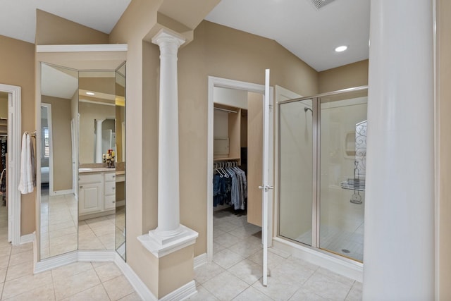 full bathroom featuring tile patterned flooring, vanity, a shower stall, a walk in closet, and ornate columns