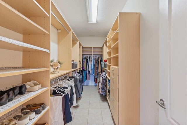 walk in closet with light tile patterned flooring