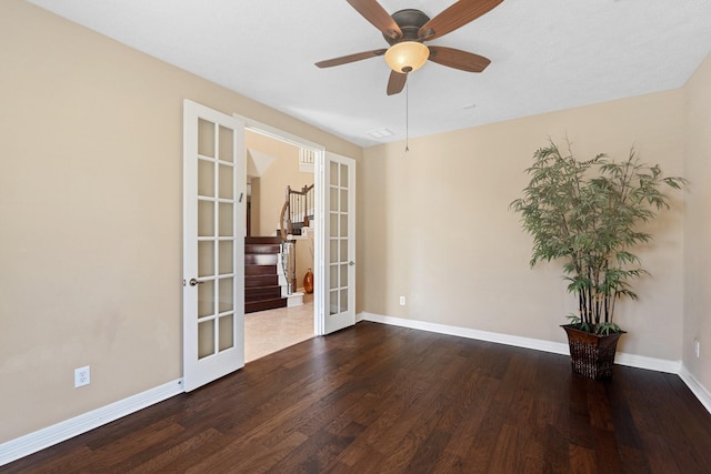 empty room featuring ceiling fan, french doors, wood finished floors, and baseboards