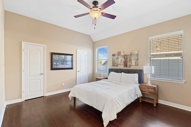 bedroom featuring a ceiling fan, lofted ceiling, baseboards, and wood finished floors