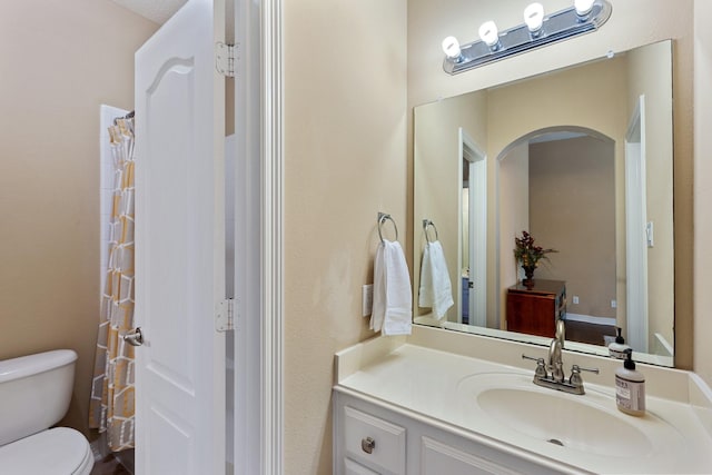 bathroom featuring vanity and toilet