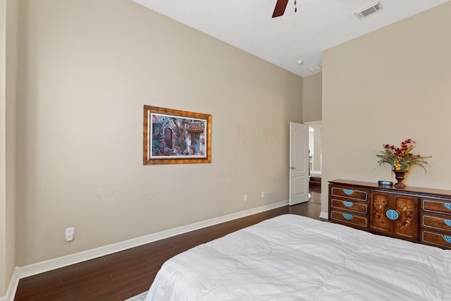 bedroom with dark wood-style floors, visible vents, baseboards, and a ceiling fan