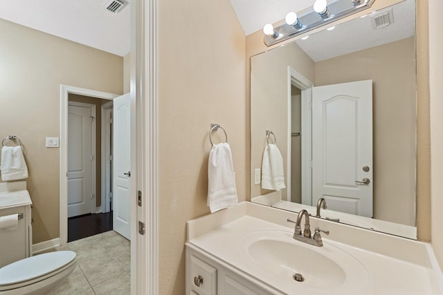 bathroom featuring visible vents, vanity, and tile patterned floors