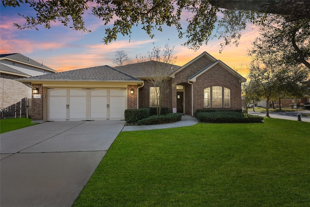 ranch-style home with an attached garage, brick siding, concrete driveway, roof with shingles, and a front yard