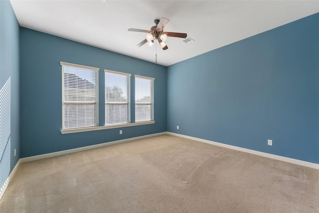 unfurnished room featuring carpet, visible vents, ceiling fan, and baseboards