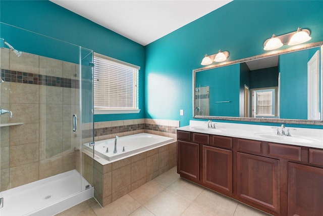 bathroom with a garden tub, a shower stall, tile patterned flooring, and a sink