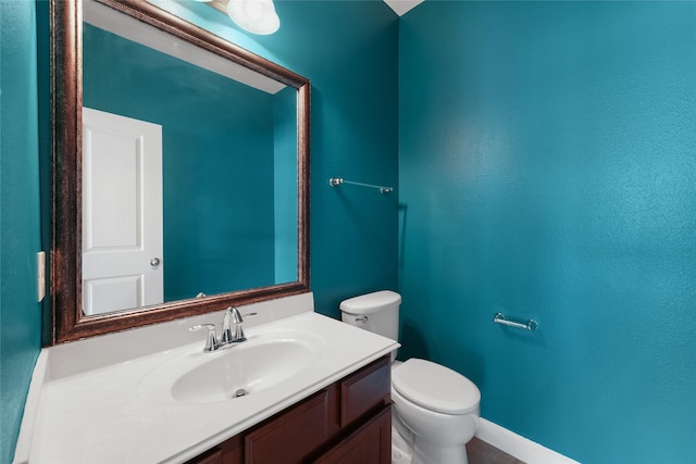 bathroom featuring toilet and vanity