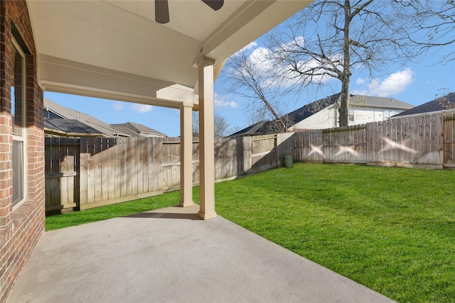 view of yard featuring a patio, a fenced backyard, and a ceiling fan