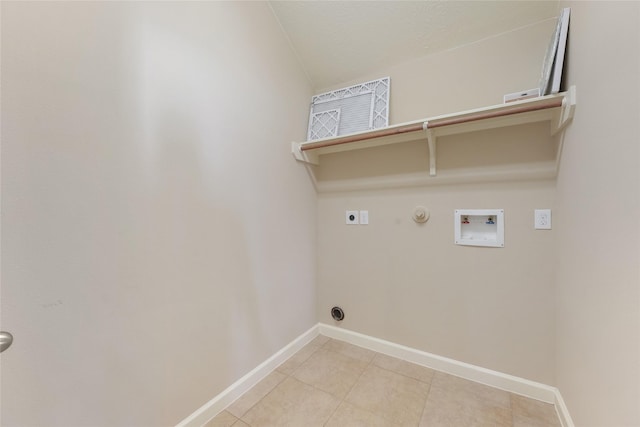 clothes washing area featuring washer hookup, hookup for a gas dryer, hookup for an electric dryer, laundry area, and baseboards