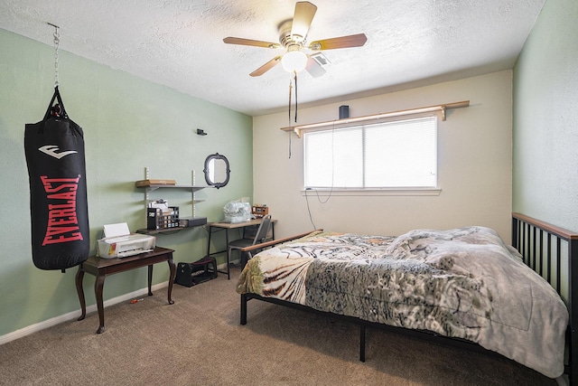 bedroom featuring a ceiling fan, a textured ceiling, baseboards, and carpet flooring