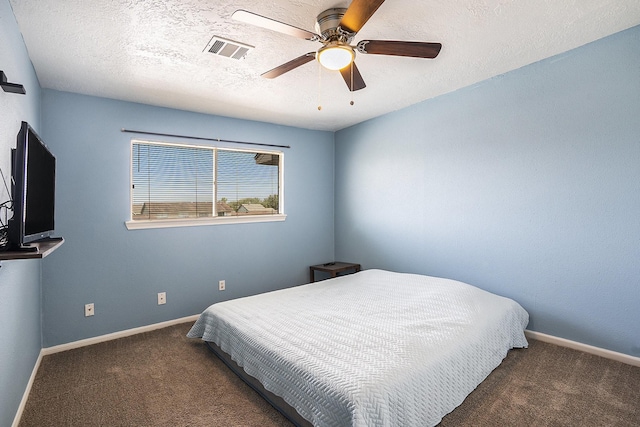 bedroom with baseboards, visible vents, a ceiling fan, a textured ceiling, and carpet floors