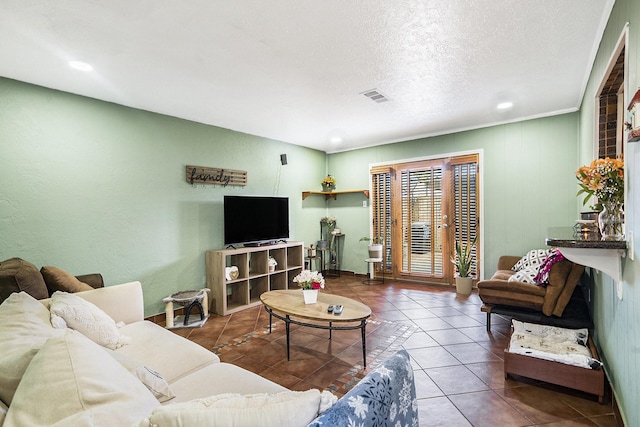 tiled living room featuring visible vents and a textured ceiling