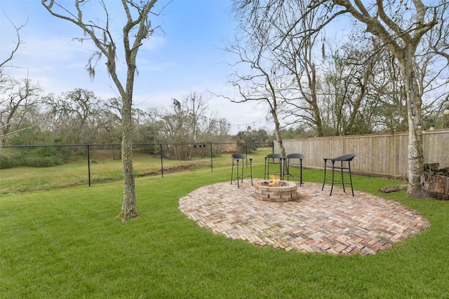 view of yard with an outdoor fire pit, a patio, and fence