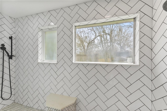 full bath featuring a tile shower