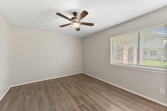 spare room with ceiling fan, baseboards, and wood finished floors