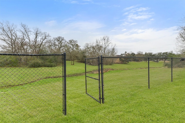 view of community with a gate, a lawn, and fence