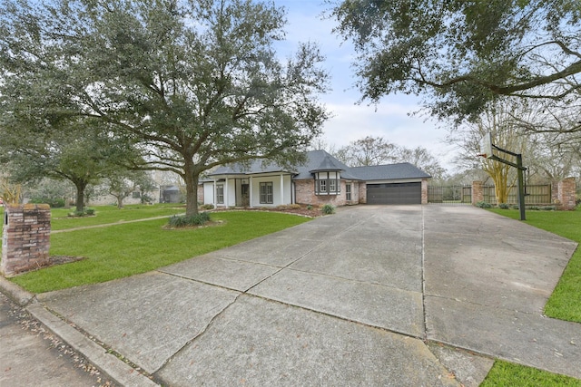 view of front of property featuring fence, an attached garage, a front lawn, concrete driveway, and brick siding