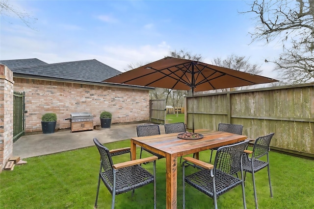 view of patio featuring area for grilling, outdoor dining space, and fence