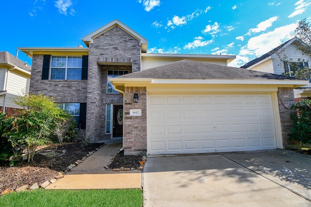 traditional home featuring a garage, a shingled roof, concrete driveway, and brick siding