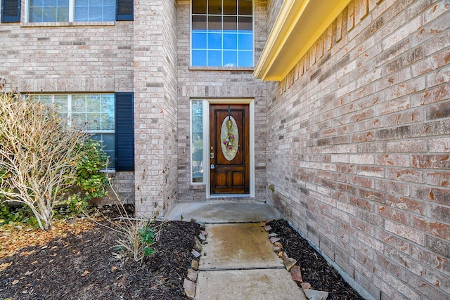 property entrance with brick siding