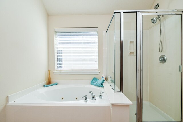 full bath with a tub with jets, a shower stall, and a healthy amount of sunlight