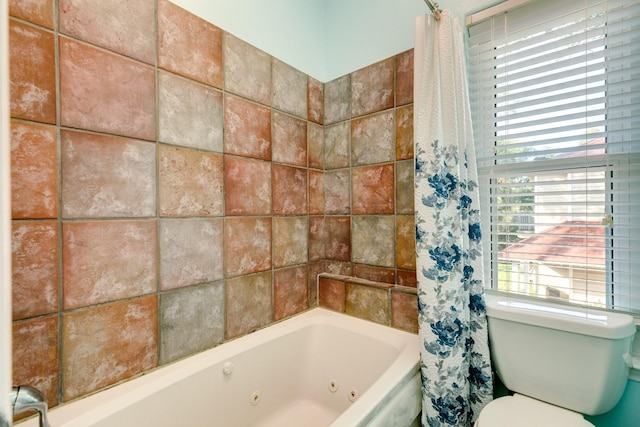 bathroom with a combined bath / shower with jetted tub and toilet