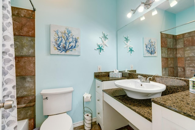 bathroom featuring toilet, shower / bath combo, and vanity