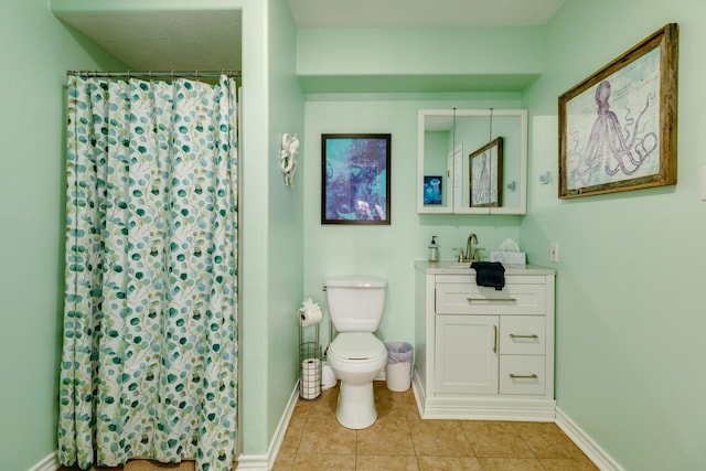 bathroom featuring baseboards, toilet, and tile patterned floors