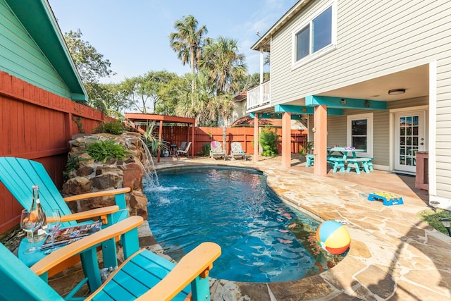 view of swimming pool featuring a fenced in pool, outdoor dining area, a patio area, and a fenced backyard