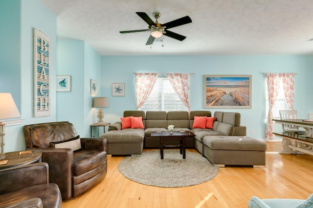 living room featuring a ceiling fan and wood finished floors