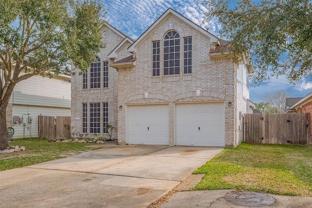 traditional home featuring concrete driveway, brick siding, and fence