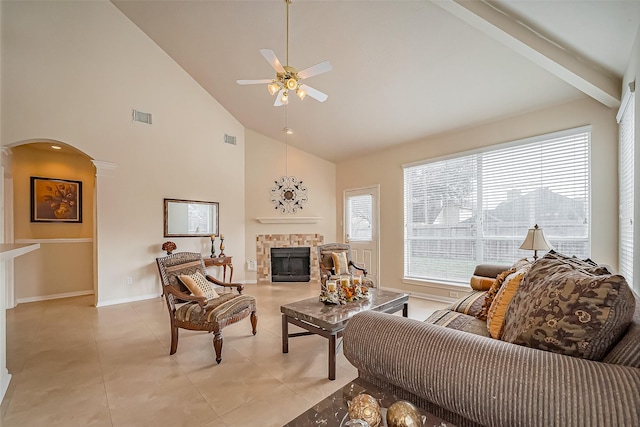 living area featuring arched walkways, visible vents, a fireplace, and light tile patterned floors