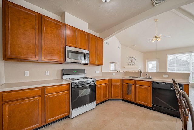 kitchen with light countertops, stainless steel microwave, a sink, gas range, and dishwasher