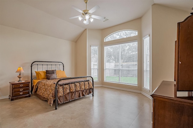 bedroom with lofted ceiling, ceiling fan, light tile patterned floors, visible vents, and baseboards