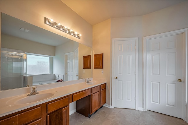 full bathroom with a garden tub, a sink, a shower stall, and double vanity