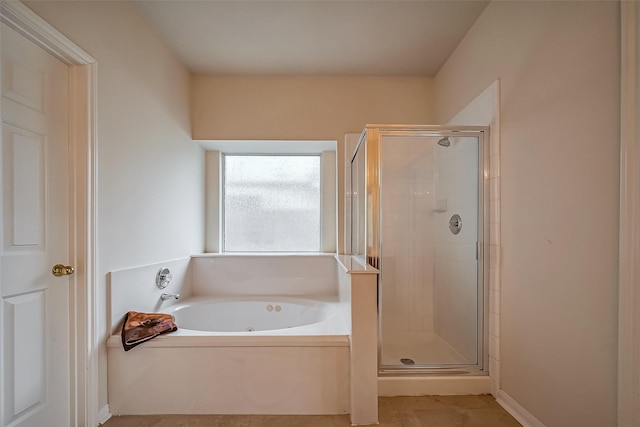 full bath featuring a garden tub and a shower stall