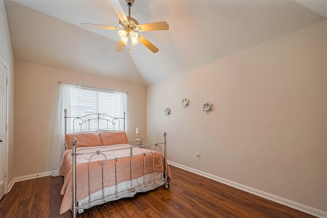 bedroom featuring dark wood finished floors, vaulted ceiling, baseboards, and ceiling fan