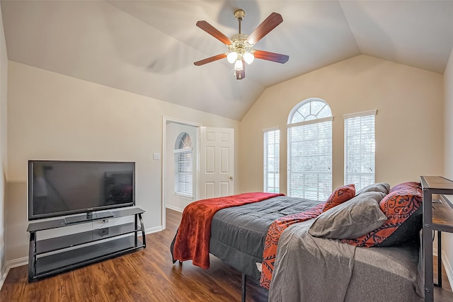 bedroom with ceiling fan, baseboards, vaulted ceiling, and wood finished floors