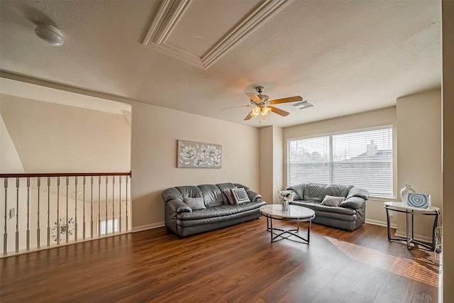 living room with visible vents, attic access, a textured ceiling, wood finished floors, and baseboards